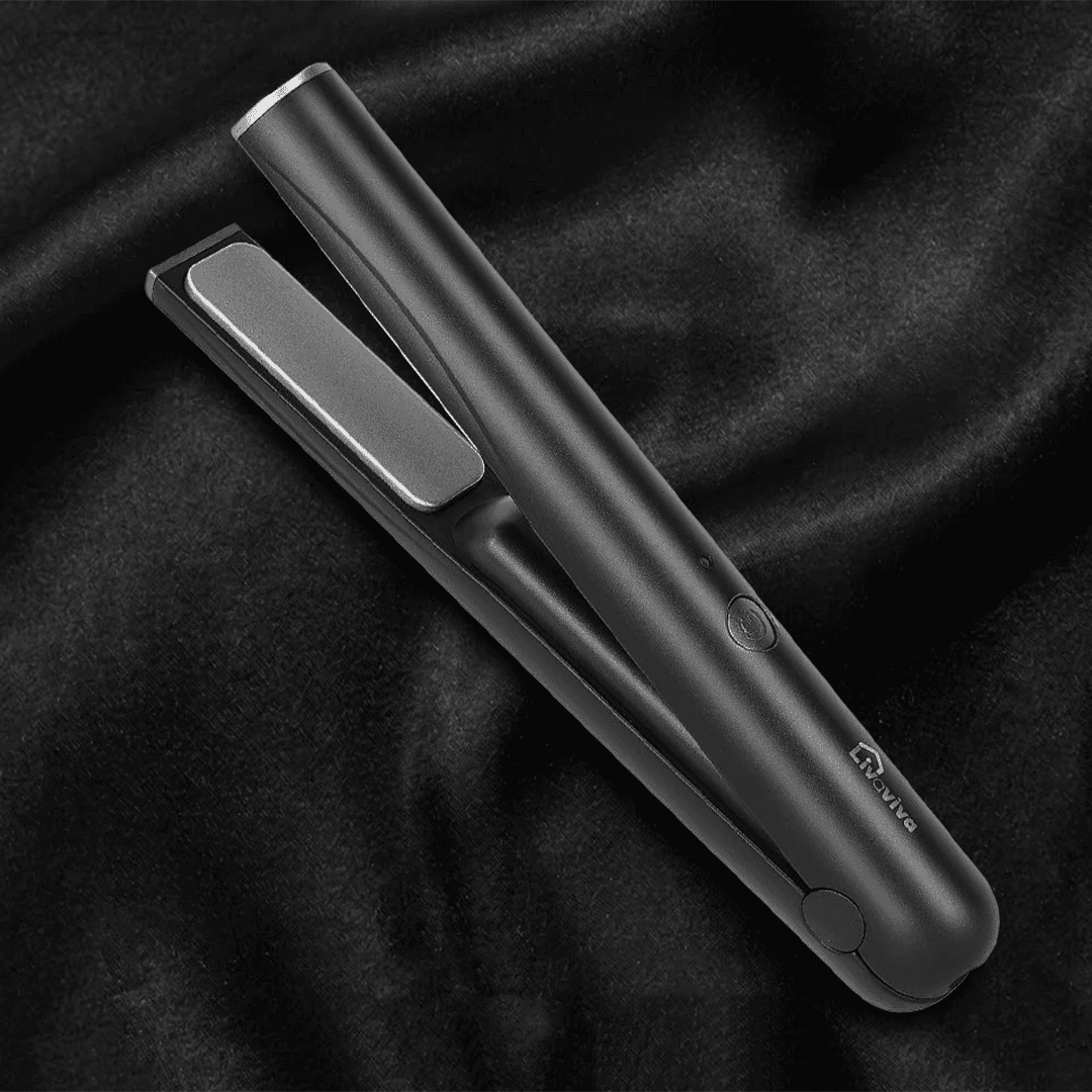 Matte black Livaviva hair straightener with grey plates on a rippled black fabric background.